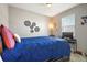 Bright bedroom with ceiling fan, large window, and blue comforter at 2451 Spring Breeze Dr, Leesburg, FL 34748