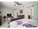Well-lit bedroom featuring a ceiling fan, comfortable seating, and a modern aesthetic at 2451 Spring Breeze Dr, Leesburg, FL 34748