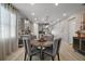 Dining area with seating for four adjacent to the kitchen and living spaces at 2451 Spring Breeze Dr, Leesburg, FL 34748
