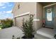 View of the home's entrance and garage, surrounded by lush landscaping at 2451 Spring Breeze Dr, Leesburg, FL 34748