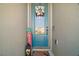Close-up of a charming front door with decorative wreath and welcome mat at 2451 Spring Breeze Dr, Leesburg, FL 34748
