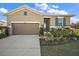 Charming single-story home with a well-manicured lawn and a two-car garage at 2451 Spring Breeze Dr, Leesburg, FL 34748
