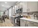 Modern kitchen with light cabinets, stainless steel appliances, and white quartz countertops at 2451 Spring Breeze Dr, Leesburg, FL 34748
