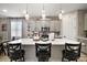 Modern kitchen with white quartz countertops, pendant lights, and stainless steel appliances at 2451 Spring Breeze Dr, Leesburg, FL 34748