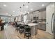 Open-concept kitchen featuring modern island with bar seating at 2451 Spring Breeze Dr, Leesburg, FL 34748