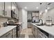Spacious kitchen with stainless steel appliances, white cabinets, and tile flooring at 2451 Spring Breeze Dr, Leesburg, FL 34748