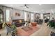Bright living room with a cozy sofa, patterned rug, and modern decor at 2451 Spring Breeze Dr, Leesburg, FL 34748