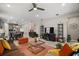 Open-concept living room features stylish decor, tile floors, and a modern ceiling fan at 2451 Spring Breeze Dr, Leesburg, FL 34748