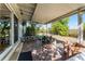 Covered back patio with brick flooring and outdoor seating, perfect for enjoying the backyard view at 2545 Dellwood Dr, Orlando, FL 32806
