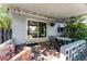 Covered back patio with brick flooring and outdoor seating, connecting to the home's interior at 2545 Dellwood Dr, Orlando, FL 32806