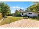 Lush backyard features a brick patio and mature trees, providing privacy and space for outdoor activities at 2545 Dellwood Dr, Orlando, FL 32806