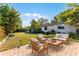 Landscaped backyard with a brick patio, outdoor furniture, and lush greenery, ideal for relaxation at 2545 Dellwood Dr, Orlando, FL 32806