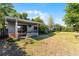 View of the house and backyard featuring a partially covered patio with table and chairs at 2545 Dellwood Dr, Orlando, FL 32806