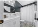 Modern bathroom with stylish vanity, round mirror, and shower with curtain at 2545 Dellwood Dr, Orlando, FL 32806