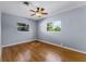 Bedroom featuring hardwood floors, a ceiling fan, and two windows at 2545 Dellwood Dr, Orlando, FL 32806