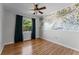 Hardwood bedroom with natural light, floral wallpaper, and dark curtains at 2545 Dellwood Dr, Orlando, FL 32806