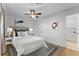 Cozy bedroom boasts neutral decor, a ceiling fan, and an ensuite bathroom, creating a relaxing retreat at 2545 Dellwood Dr, Orlando, FL 32806