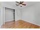 Bright bedroom featuring hardwood floors, a ceiling fan, and a spacious closet at 2545 Dellwood Dr, Orlando, FL 32806