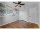 Bedroom boasting stylish wallpaper, hardwood floors, and a ceiling fan at 2545 Dellwood Dr, Orlando, FL 32806