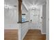 Welcoming foyer featuring hardwood floors, a paneled wall, stylish lighting, and a bright, airy ambiance at 2545 Dellwood Dr, Orlando, FL 32806