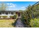 Inviting front entrance with a brick walkway, decorative wreath, and well-maintained landscaping at 2545 Dellwood Dr, Orlando, FL 32806