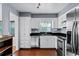 Bright kitchen showcasing stainless steel appliances, dark countertops, and white cabinetry, blending style with practicality at 2545 Dellwood Dr, Orlando, FL 32806