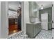 Functional laundry room with green cabinets, patterned tile floor, and modern washer/dryer at 2545 Dellwood Dr, Orlando, FL 32806
