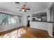 Bright living room features hardwood floors, a large window, and access to the kitchen at 2545 Dellwood Dr, Orlando, FL 32806