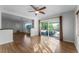 Bright living room features hardwood floors, a ceiling fan, and sliding glass doors to the patio at 2545 Dellwood Dr, Orlando, FL 32806