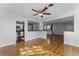 Bright living room features hardwood floors, an open layout, and access to the kitchen at 2545 Dellwood Dr, Orlando, FL 32806