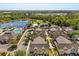 Stunning aerial view of the community with lush trees, lake, pool and perfectly lined townhomes at 2624 Lodi Cir # 101, Kissimmee, FL 34746