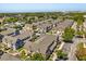Aerial view of community townhomes, manicured landscaping, and tree lined streets at 2624 Lodi Cir # 101, Kissimmee, FL 34746