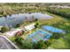 A captivating aerial view of community amenities including a splash park, lake, and sports courts at 2624 Lodi Cir # 101, Kissimmee, FL 34746