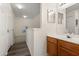 Upstairs bathroom with wood cabinet, sink, mirror and stairway access at 2624 Lodi Cir # 101, Kissimmee, FL 34746