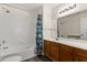 This bathroom features a tub with a shower and vanity offering both style and functionality at 2624 Lodi Cir # 101, Kissimmee, FL 34746