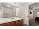 Bright bathroom features a white countertop, wood cabinets, and a view into the bedroom at 2624 Lodi Cir # 101, Kissimmee, FL 34746