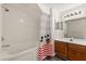 Bright bathroom featuring a tub with jets, shower, vanity with lots of storage, and decor at 2624 Lodi Cir # 101, Kissimmee, FL 34746
