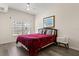 Cozy bedroom showcasing a large window, a ceiling fan, and a comfortable bed at 2624 Lodi Cir # 101, Kissimmee, FL 34746