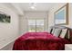 Bright bedroom features a large window, ceiling fan, and a comfortable queen bed at 2624 Lodi Cir # 101, Kissimmee, FL 34746