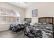 Bright bedroom features two twin beds, a light gray floor, and a window letting in natural light at 2624 Lodi Cir # 101, Kissimmee, FL 34746