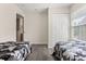 Neutral bedroom with light gray floors features closet and twin beds with gray patterned blankets at 2624 Lodi Cir # 101, Kissimmee, FL 34746