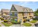 Attractive townhome showcasing neat landscaping, a red front door, and a well-maintained lawn, offering appealing curb appeal at 2624 Lodi Cir # 101, Kissimmee, FL 34746