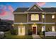 Charming townhome with a well-maintained lawn and a vibrant red front door, creating an inviting curb appeal at 2624 Lodi Cir # 101, Kissimmee, FL 34746