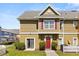 Charming townhome featuring a bright red front door and complemented by neat landscaping, offering great curb appeal at 2624 Lodi Cir # 101, Kissimmee, FL 34746