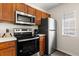 Well-equipped kitchen with stainless steel appliances, including a microwave, oven, and refrigerator at 2624 Lodi Cir # 101, Kissimmee, FL 34746