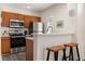 This kitchen features stainless steel appliances and wood cabinets offering a modern and functional cooking space at 2624 Lodi Cir # 101, Kissimmee, FL 34746