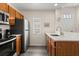 Bright kitchen with wood cabinets, stainless steel refrigerator and plenty of counter space for meal prep at 2624 Lodi Cir # 101, Kissimmee, FL 34746