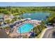 Aerial view shows pool, hot tub, lake and lounge area at 2624 Lodi Cir # 101, Kissimmee, FL 34746
