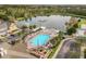 Aerial view features a pool, lounge chairs, hot tub and large lake at 2624 Lodi Cir # 101, Kissimmee, FL 34746