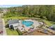 Aerial view of a community pool with lounge chairs, picnic tables, a clubhouse and a playground at 2805 Bookmark Dr, Kissimmee, FL 34746
